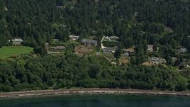 5K aerial stock footage of waterfront mansions and trees near the shore, Shoreline, Washington Aerial Stock Footage | AX45_116