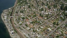 5K aerial stock footage approach train tracks and a waterfront community, Shoreline, Washington Aerial Stock Footage | AX45_118