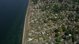 5K aerial stock footage tilt from bird's eye of railroad tracks and waterfront suburban homes, Edmonds and Lynnwood, Washington Aerial Stock Footage | AX45_125E