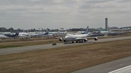 5K aerial stock footage of tracking a 747 taxiing down a runway, Paine Field, Washington Aerial Stock Footage | AX45_147