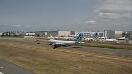 5K aerial stock footage reverse view of a 747 taxiing down a runway near Boeing Factory, Paine Field, Washington Aerial Stock Footage | AX45_149