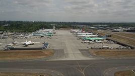 5K aerial stock footage of rows of commercial airplanes parked at Paine Field, Washington Aerial Stock Footage | AX45_150
