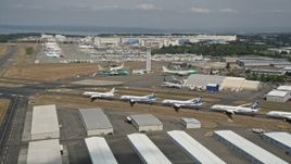 5K aerial stock footage of panning across a row of six airliners at Paine Field, reveal Boeing Factory, Washington Aerial Stock Footage | AX45_152E