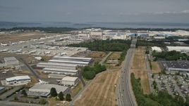 5K aerial stock footage approach the Boeing Factory and pan to parked airliners, Paine Field, Washington Aerial Stock Footage | AX45_154