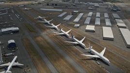 5K aerial stock footage approach and fly over a row of parked airliners, Paine Field, Washington Aerial Stock Footage | AX46_003