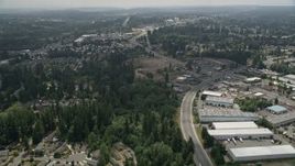 5K aerial stock footage follow road between homes and warehouse buildings to approach a mobile homes park, Lynnwood, Washington Aerial Stock Footage | AX46_005