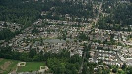 5K aerial stock footage flying by suburban homes around a pond, Brier, Washington Aerial Stock Footage | AX46_014