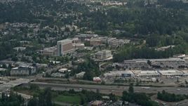 A view of Evergreen Hospital Medical Center and a strip mall, Kirkland, Washington Aerial Stock Footage | AX46_022