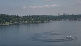 5K aerial stock footage of tracking a speedboat pulling a raft on Lake Washington, Washington Aerial Stock Footage | AX46_046