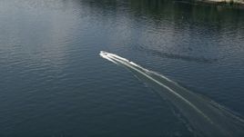 5K aerial stock footage track a speedboat pulling a raft on Lake Washington, Washington Aerial Stock Footage | AX46_049