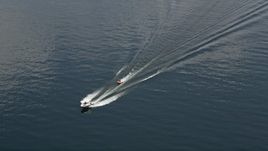 5K aerial stock footage track a speedboat towing a raft across Lake Washington, Washington Aerial Stock Footage | AX46_051