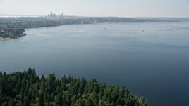 5K aerial stock footage fly over Lake Washington to approach bridge and the Downtown Seattle skyline in Washington Aerial Stock Footage | AX47_009