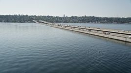5K aerial stock footage flyby lakeside homes, bridge spanning Lake Washington, reveal downtown skyline, Mercer Island, Seattle, Washington Aerial Stock Footage | AX47_010E