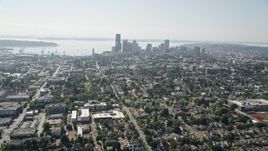 5K aerial stock footage tilt from park to reveal urban homes in Central Seattle and the Downtown Seattle skyline, Washington Aerial Stock Footage | AX47_015E