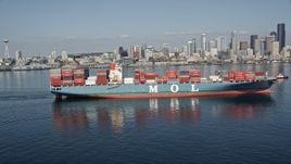 5K aerial stock footage orbit a cargo ship sailing Elliott Bay with the skyline in the background, Downtown Seattle, Washington Aerial Stock Footage | AX47_026E