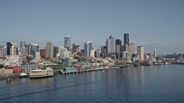 5K aerial stock footage of Downtown Seattle skyline and Central Waterfront piers seen from Elliott Bay, Washington Aerial Stock Footage | AX47_032