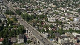 5K aerial stock footage fly over Lake Union to approach Aurora Bridge and light traffic crossing the span, Seattle, Washington Aerial Stock Footage | AX47_067