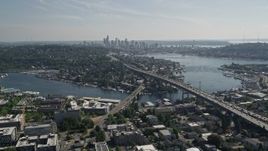 5K aerial stock footage fly away from Ship Canal Bridge and tilt to reveal Lake Union and the skyline of Downtown Seattle, Washington Aerial Stock Footage | AX47_078