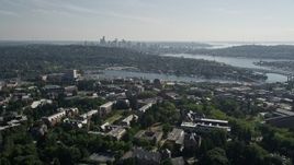 5K aerial stock footage tilt from the University of Washington campus to reveal Portage Bay, Lake Union, and the skyline of Downtown Seattle, Washington Aerial Stock Footage | AX47_088E
