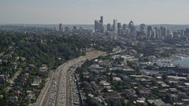 5K aerial stock footage tilt from heavy traffic on Interstate 5 to reveal and approach the Downtown Seattle skyline, Washington Aerial Stock Footage | AX47_091