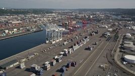 5K aerial stock footage of cargo cranes and rows of shipping containers at Harbor Island, Seattle, Washington Aerial Stock Footage | AX47_101E
