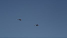 5K aerial stock footage of tracking two Kiowa Warrior helicopters over Downtown Seattle, blue skies, Washington Aerial Stock Footage | AX47_107E
