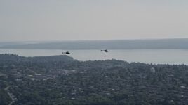 5K aerial stock footage of two Kiowa Warrior helicopters in flight over Seattle, Washington Aerial Stock Footage | AX47_110E