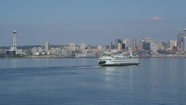 5K aerial stock footage fly low to approach and pass a ferry sailing toward the Downtown Seattle skyline in Washington Aerial Stock Footage | AX47_117