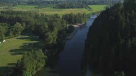 5K aerial stock footage fly over a bridge on the Snoqualmie River to approach a second bridge in Carnation, Washington Aerial Stock Footage | AX48_032