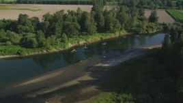 5K aerial stock footage fly over the Snoqualmie River and a farm field in Carnation, Washington Aerial Stock Footage | AX48_036