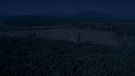 4K day for night color corrected aerial stock footage of a logging clear cut area in an evergreen forest, King County, Washington Aerial Stock Footage | AX48_048_DFN