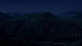 4K day for night color corrected aerial stock footage of flying over a wooded mountain in King County, Seattle, Washington Aerial Stock Footage | AX48_053_DFN