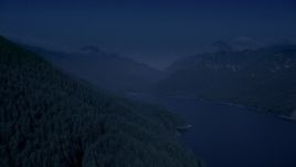 4K day for night color corrected aerial stock footage of evergreen trees on mountain slope next to the South Fork Tolt Reservoir, Cascade Range, Washington Aerial Stock Footage | AX48_059_DFN