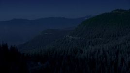 4K day for night color corrected aerial stock footage of a mountain ridge and evergreen trees on mountain slopes, Cascade Range, Washington Aerial Stock Footage | AX48_063_DFN