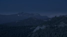 4K day for night color corrected aerial stock footage of evergreen trees on the slope of a mountain ridge in the Cascade Range, Washington Aerial Stock Footage | AX48_064_DFN