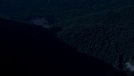4K day for night color corrected aerial stock footage of a bird's eye of a river through evergreen forest in the Cascade Range, Washington Aerial Stock Footage | AX48_065_DFN