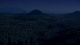 4K day for night color corrected aerial stock footage of evergreen forest, reveal a green hill and logging areas in King County, Washington Aerial Stock Footage | AX48_077_DFN