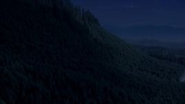 4K day for night color corrected aerial stock footage of approach and pan across a ridge with evergreen trees in King County, Washington Aerial Stock Footage | AX48_078_DFN