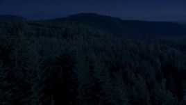 4K day for night color corrected aerial stock footage of a vast evergreen forest on a ridge in the Cascade Range, Washington Aerial Stock Footage | AX48_082_DFN