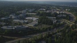 5K aerial stock footage of passing by Microsoft Headquarters office complex beside freeway with light traffic in Redmond, Washington Aerial Stock Footage | AX49_045