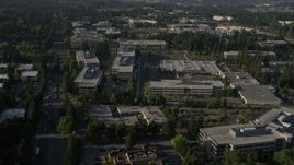 5K aerial stock footage of passing by Microsoft Headquarters office complex beside freeway with light traffic in Redmond, Washington Aerial Stock Footage | AX49_045E