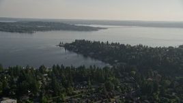 5K aerial stock footage fly over suburban neighborhoods toward waterfront homes on Lake Washington, Bellevue, Washington Aerial Stock Footage | AX49_051E