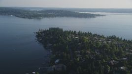 5K aerial stock footage of flying by lakeside homes with docks on the shore of Lake Washington, Bellevue, Washington Aerial Stock Footage | AX49_052