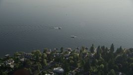 5K aerial stock footage fly over lakeside houses to approach fishing boats on Lake Washington, Bellevue, Washington Aerial Stock Footage | AX49_053