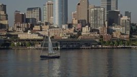 5K aerial stock footage track a sailboat raising sail on Elliott Bay, Seattle, Washington Aerial Stock Footage | AX49_067E