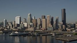 5K aerial stock footage low flyby of Central Waterfront piers, ferry terminal, and Downtown Seattle skyline, Washington Aerial Stock Footage | AX49_082E