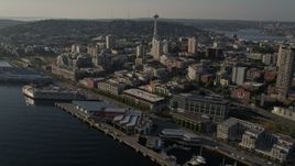 5K aerial stock footage of the iconic Seattle Space Needle seen from Central Waterfront piers, Downtown Seattle, Washington Aerial Stock Footage | AX49_086