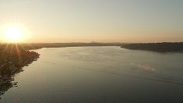 5K aerial stock footage of flying over Lake Washington toward the setting sun Aerial Stock Footage | AX50_001