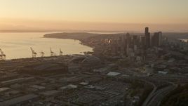 5K aerial stock footage approach CenturyLink, Safeco Field, port cargo cranes, and skyscrapers, Downtown Seattle, Washington, sunset Aerial Stock Footage | AX50_006E
