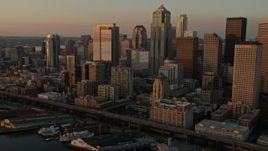 5K aerial stock footage of Downtown Seattle skyscrapers and Central Waterfront piers in Washington, sunset Aerial Stock Footage | AX50_009E